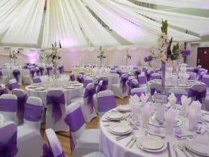 wedding tables with purple ribbons
