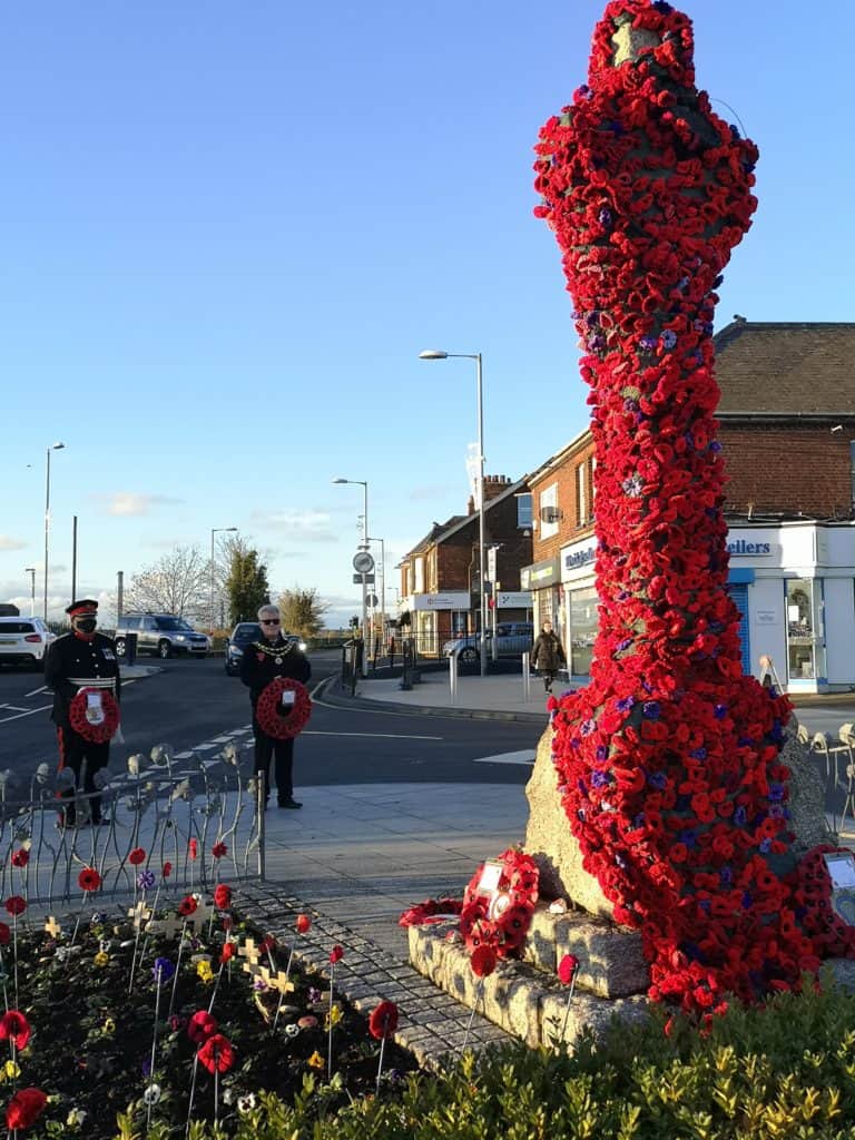 War memorial with red poppies