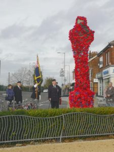 people standing at war memorial