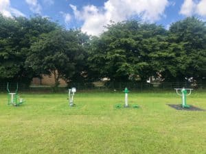four pieces of green gym equipment