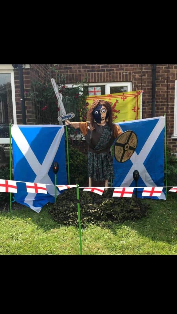 scottish scarecrow with flags and shield