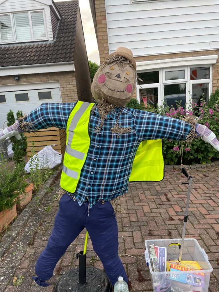 scarecrow with coloured shirt and high vis jacket