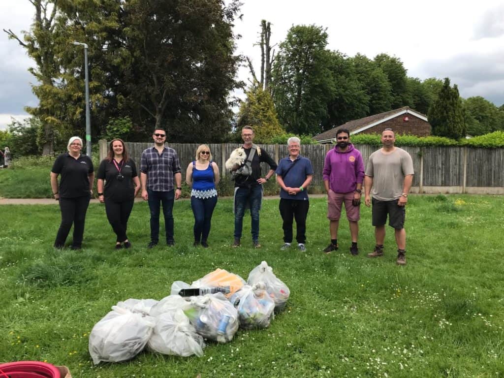 group of people with litter bags