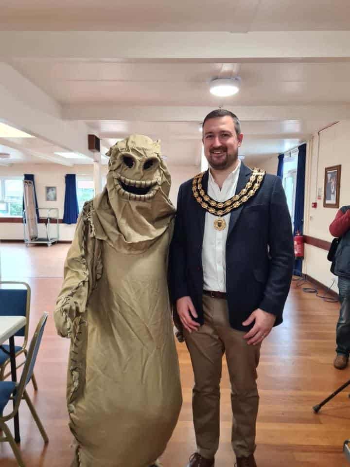 man in monster costume and mayor