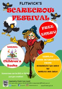 poster showing a colourful scarecrow to advertise festival in July