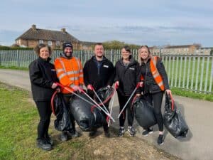 group of people at litter pick with bin bags