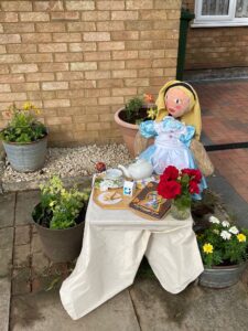 girl sitting at a table scarecrow