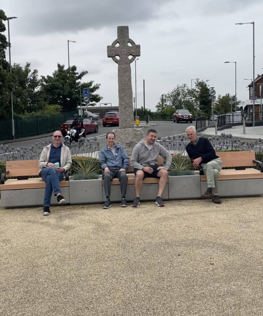 councillors sitting on new benches in fltiwick town square