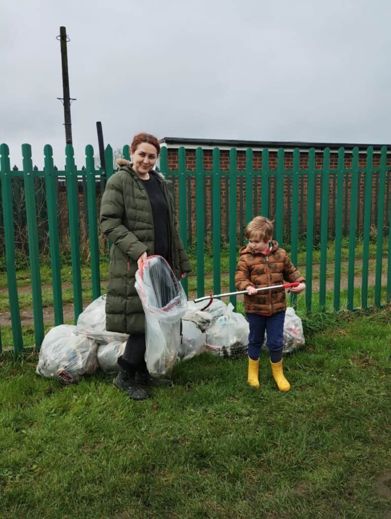 people litter picking in field