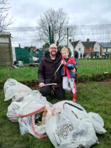 people litter picking in field