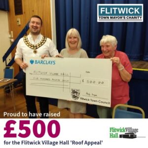 giant cheque being presented to village hall committee