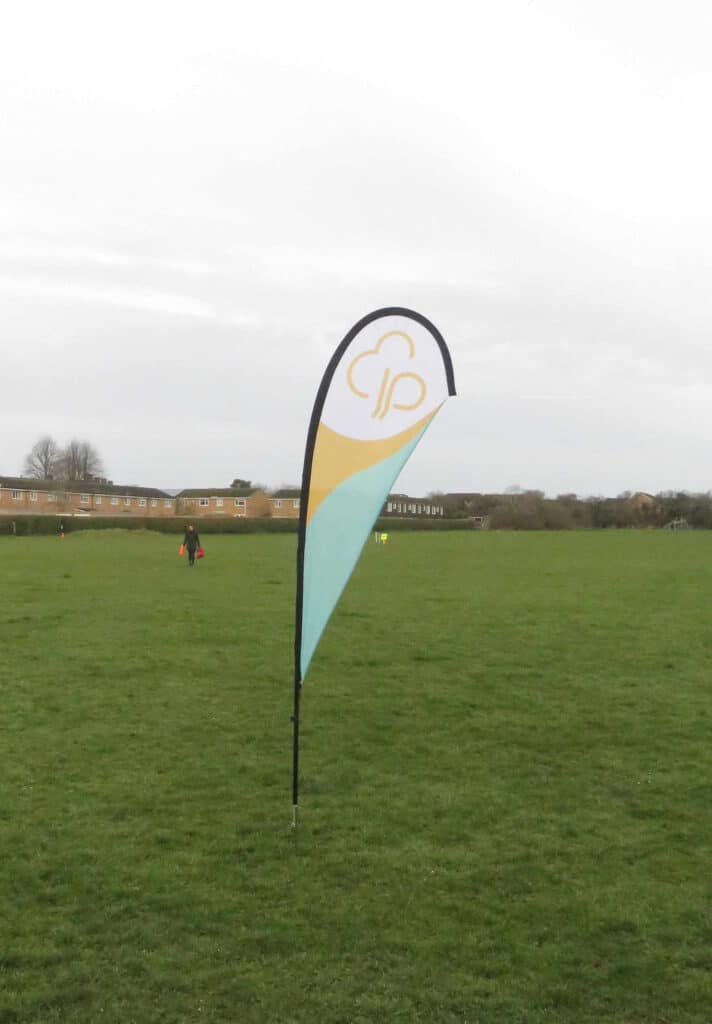 junior park run flag in a green field