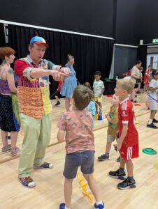 Photo showing adults and children at the circus workshop